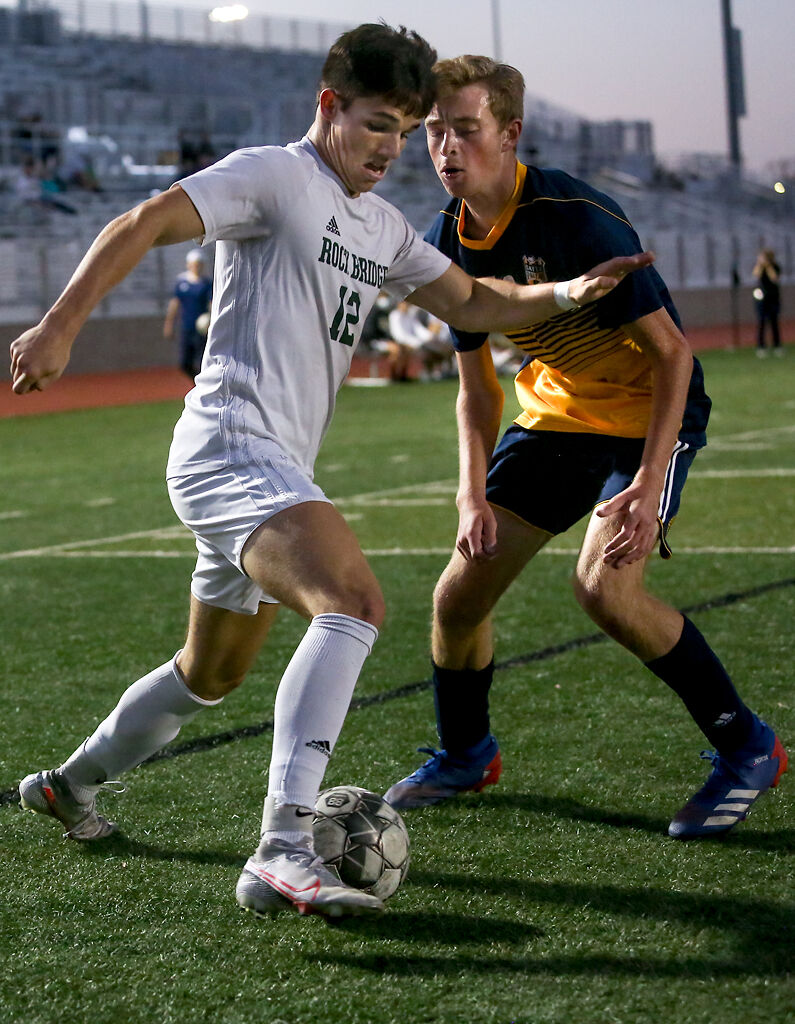 Rock Bridge senior Lucas Godon attempts to outmaneuver Battle junior Robert Lee